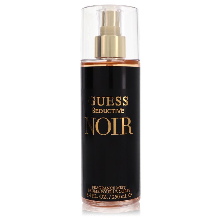 Dark blue bottle of Guess Seductive Noir body mist with gold accents, standing on a white surface, labeled "8.4 oz / 250 ml"