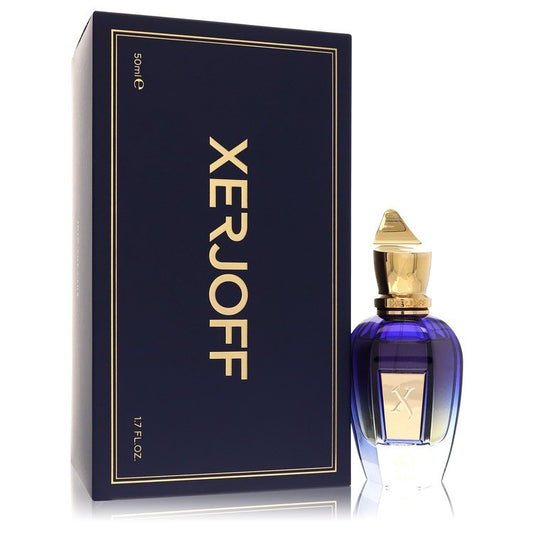 A clear glass bottle with a black cap and gold label labeled 40 Knots by Xerjoff, standing on a wooden surface.