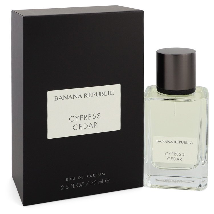A clear glass perfume bottle with a wooden cap and gold label, featuring a minimalist design, by The Fragrance Avenue.