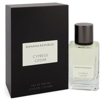 A clear glass perfume bottle with a wooden cap and gold label, featuring a minimalist design, by The Fragrance Avenue.