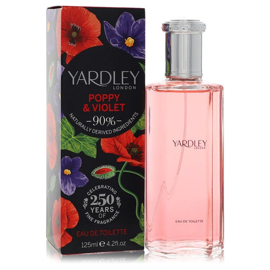 A pink and white floral fragrance bottle with a glass cap, standing on a wooden surface, labeled Yardley Poppy & Violet Eau D