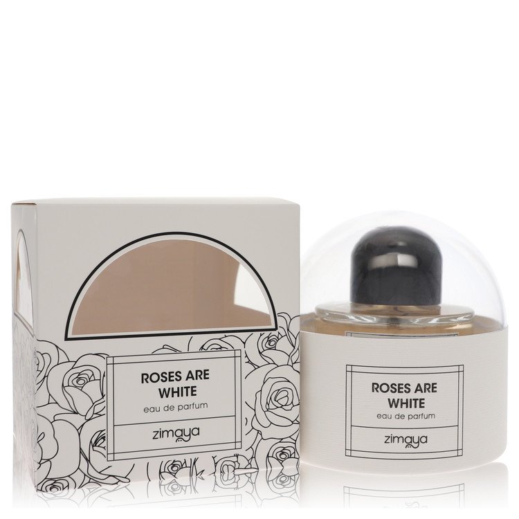 Afnan Zimaya Roses Are White eau de parfum spray in a white glass bottle with gold accents, standing on a wooden surface by T