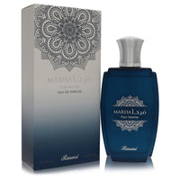 Blue glass bottle with gold cap, standing on a wooden surface, labeled Rasasi Marha Eau De Parfum Spray for Men by The Fragra