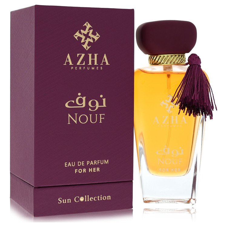 A clear glass perfume bottle with a gold cap and minimalist label, featuring the brand name Azha Nouf on a white background b