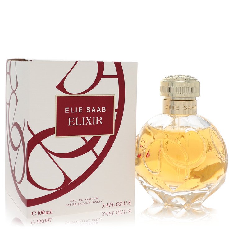 A clear glass bottle with gold accents and a white label featuring the Elie Saab logo, standing on a white background by The 