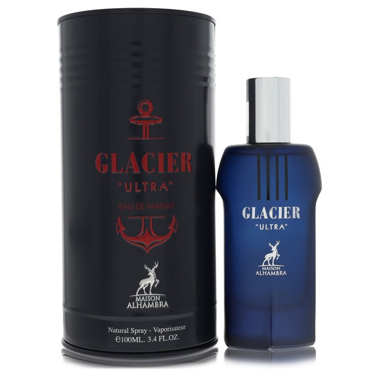 A blue glass bottle with a silver cap, standing on a wooden surface, labeled "Maison Alhambra Glacier Ultra" by The Fragrance