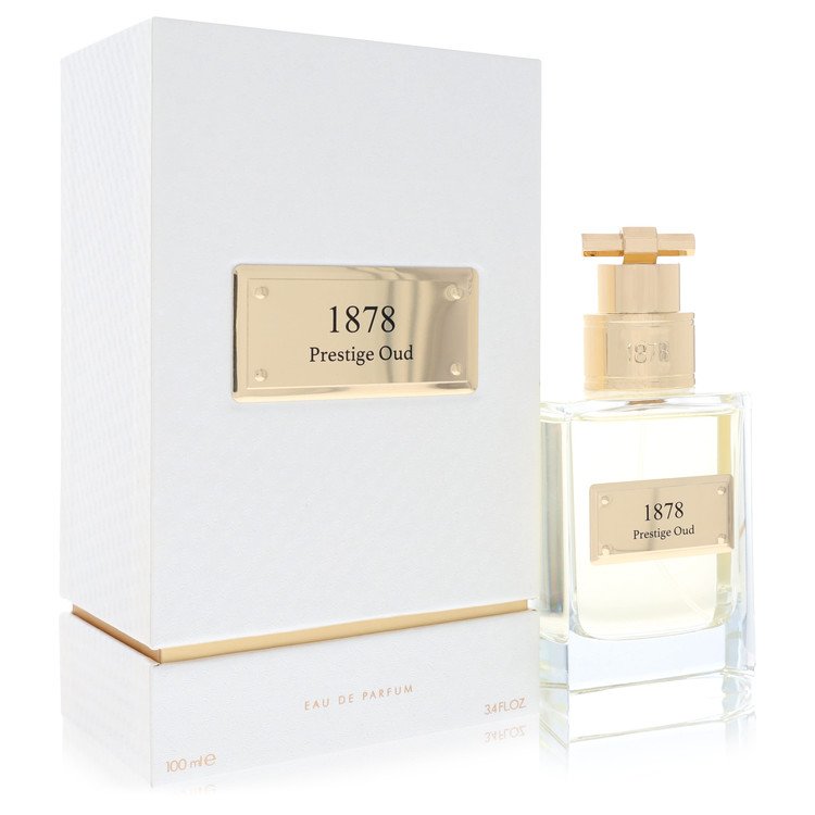 Atralia Prestige Oud Eau De Parfum Spray in a sleek black bottle with gold accents, displayed on a wooden surface by The Frag