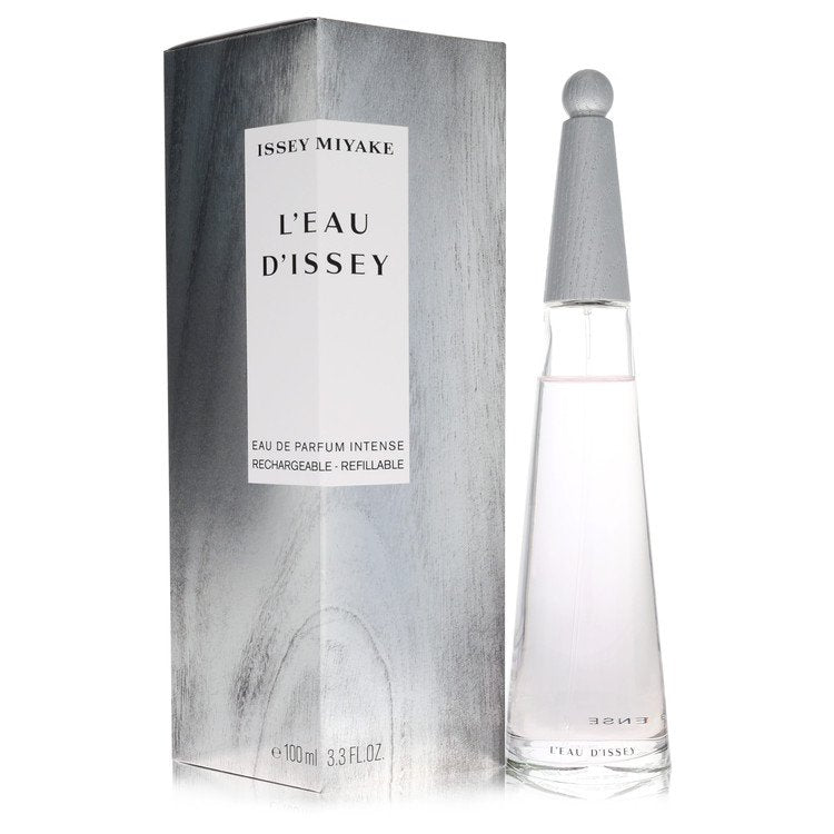 Blue glass bottle with silver cap, standing on a white surface, labeled L'eau D'issey Intense by The Fragrance Avenue.