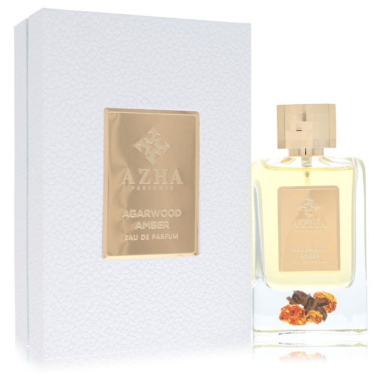 Dark amber bottle with intricate design on a wooden surface by The Fragrance Avenue.