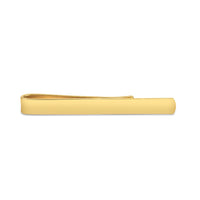 A gold plated tie slide with a polished finish, displayed on a black background, by Benson & Clegg.