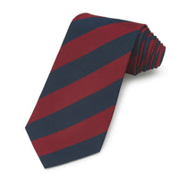 A three-fold silk tie in navy blue with a subtle pattern, displayed on a white background, part of the Household Division col