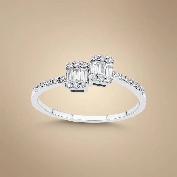 A 14ct white gold ring with two baguette diamonds and a 0.25ct center diamond, featuring an open design by Majestic Jewellery