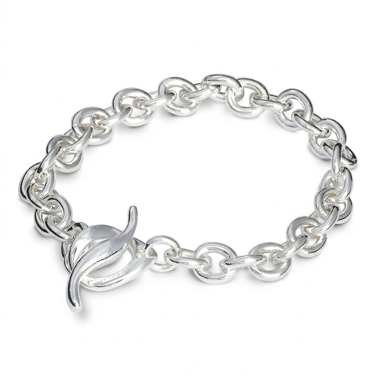 A silver charm bracelet with a heart-shaped charm, detailed engravings, and a polished finish by Scarlett Jewellery.