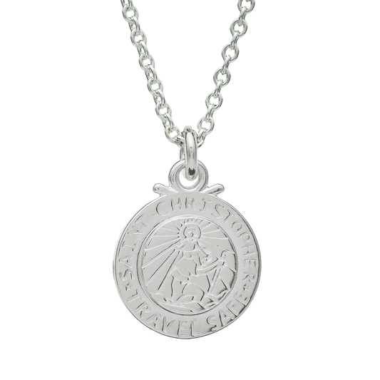 Silver St Christopher pendant on a chain with personalized engraving, styled on a wooden table.
